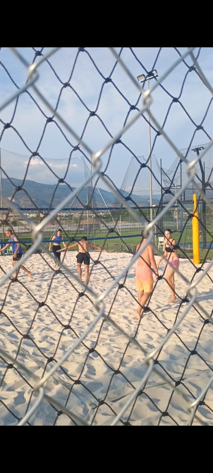 Players competing on the sand court