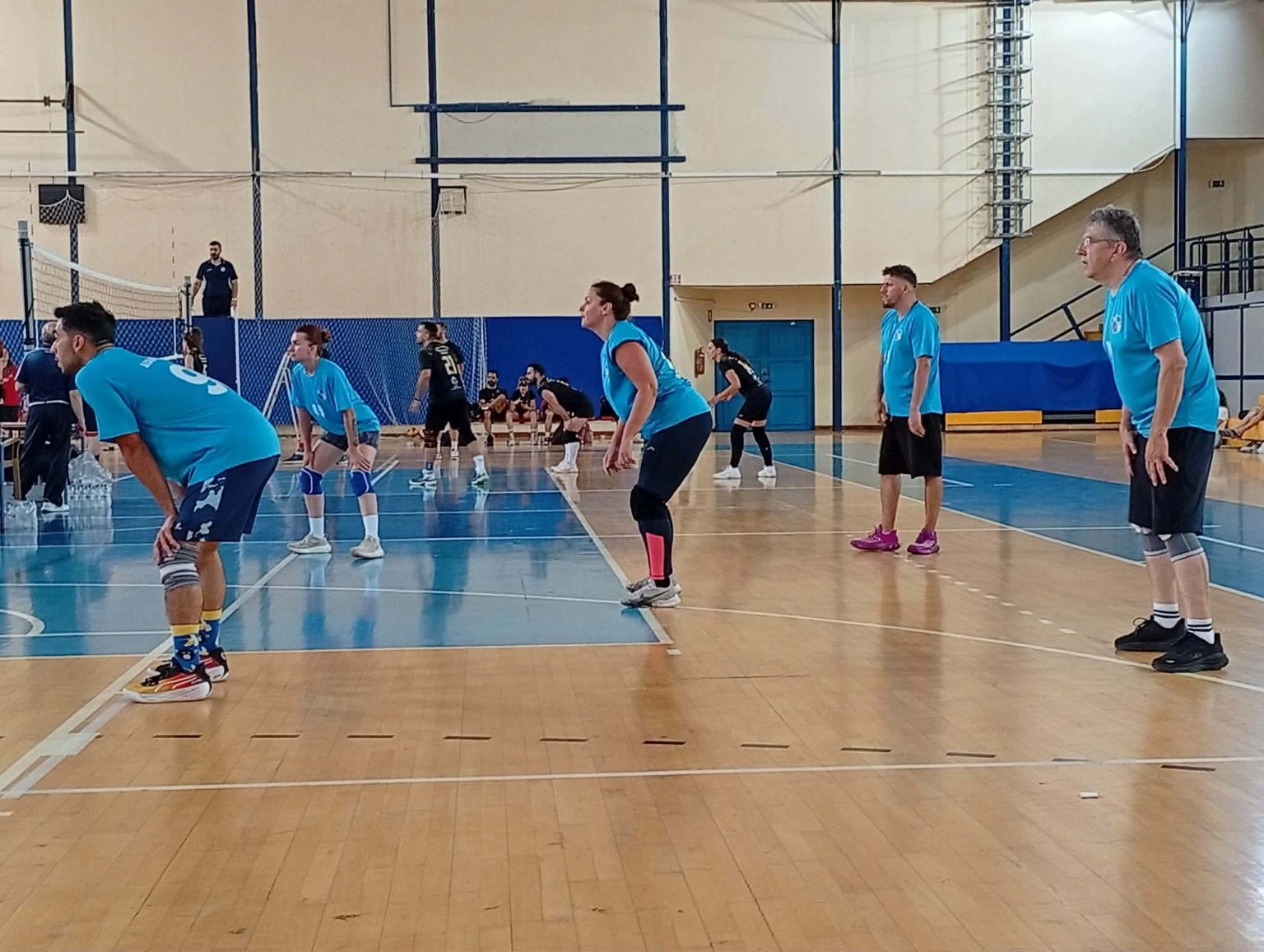 Players in action on the indoor volleyball court
